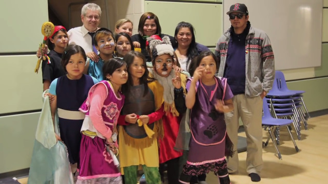 Photo of Jackie Hookimaw-Witt with children of Attawapiskat taking part in performance art inspired by indigenous ways of learning.