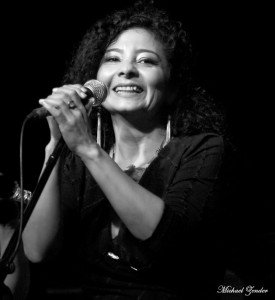 Photo of Rosy Cervantes, smiling at a microphone